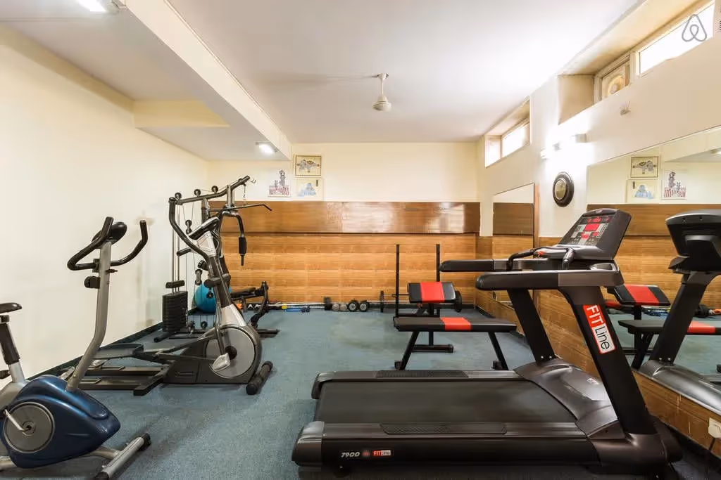 Gym in the basement of the perch sector 40 building for the convenience of guests coming to this service apartment near Cyber Park