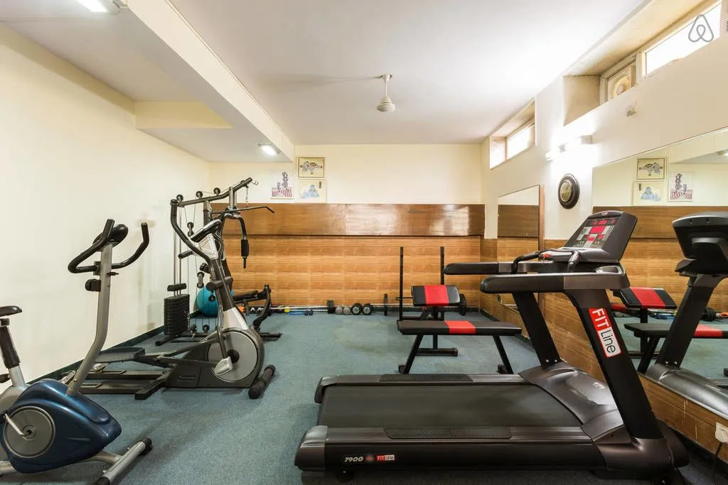 Gym in the basement of the perch sector 40 building for the convenience of guests coming to this service apartment near Cyber Park