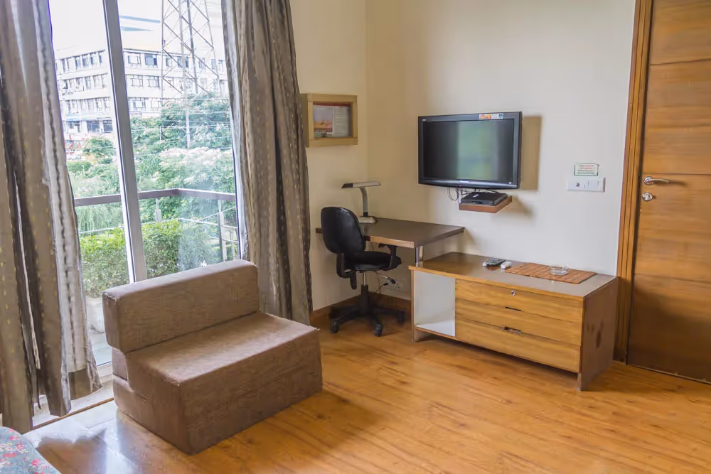 Green view right outside the 2BHK serviced apartment. The top floor apartment also have balconies along with nice amenities in the room - ideal for short stay guest looking for serviced apartments on rent