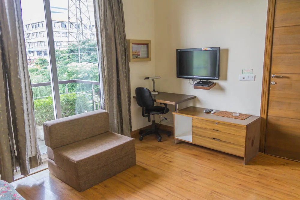 Green view right outside the 2BHK serviced apartment. The top floor apartment also have balconies along with nice amenities in the room - ideal for short stay guest looking for serviced apartments on rent
