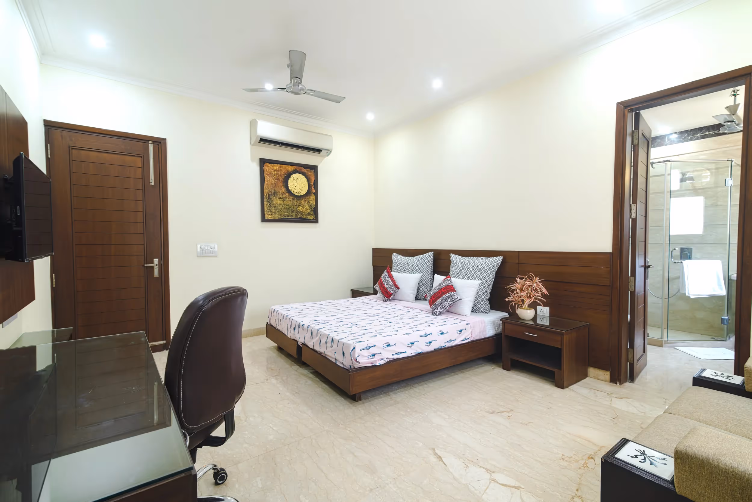 Work desk, chair, bed, in the studio apartment - Lots of natural ligjht in this serviced studio apartment near Sushant lok