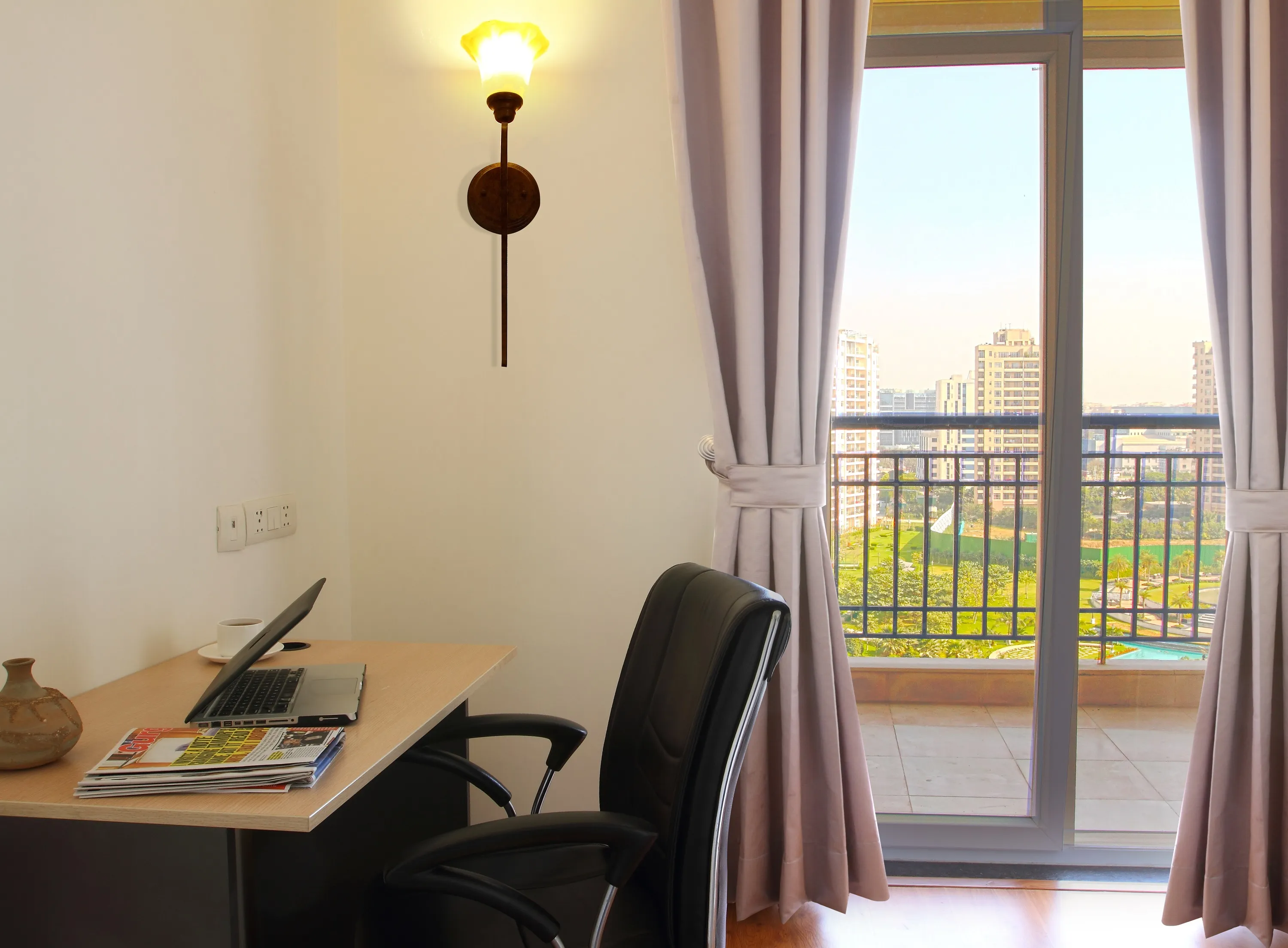 work desk and chair for the professional - with a view of the balcony in the background and a view of the vast green areas