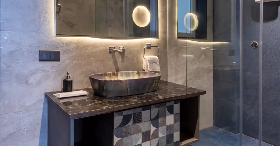 Bathroom at 2BHK in Casa Feliz by Perch Serviced Apartments features stylish vanity, black stone sink, and premium fittings