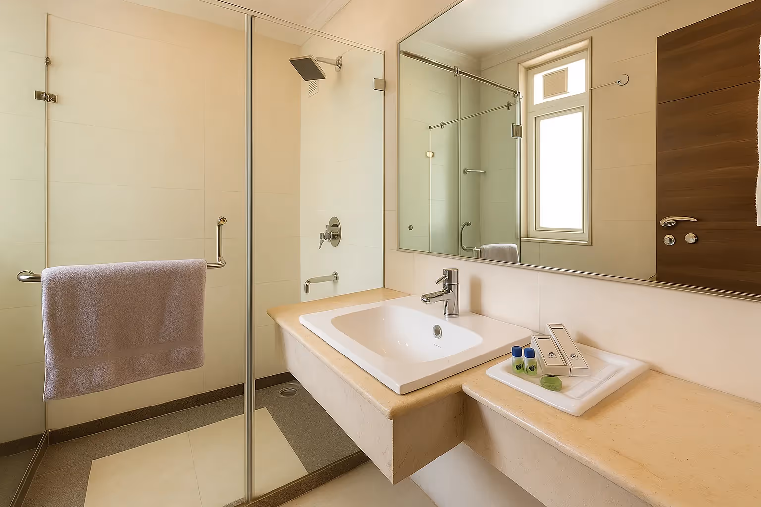 Bathroom in 1BHK Apartment Sector 40 by Perch with glass shower enclosure and sleek vanity—ideal for guests looking for hotel-style comfort and cleanliness.