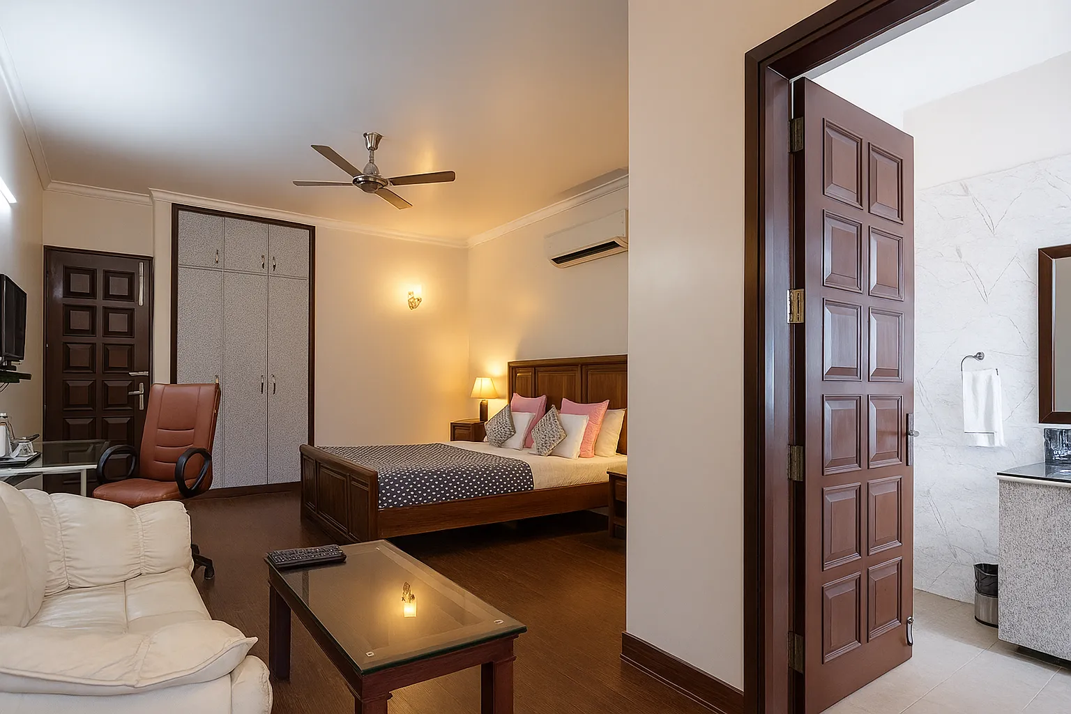 Sterling Studio Apartment in Sushant Lok featuring a comfortable bed, sofa, and attached bathroom for convenience – perfect for long stays.
