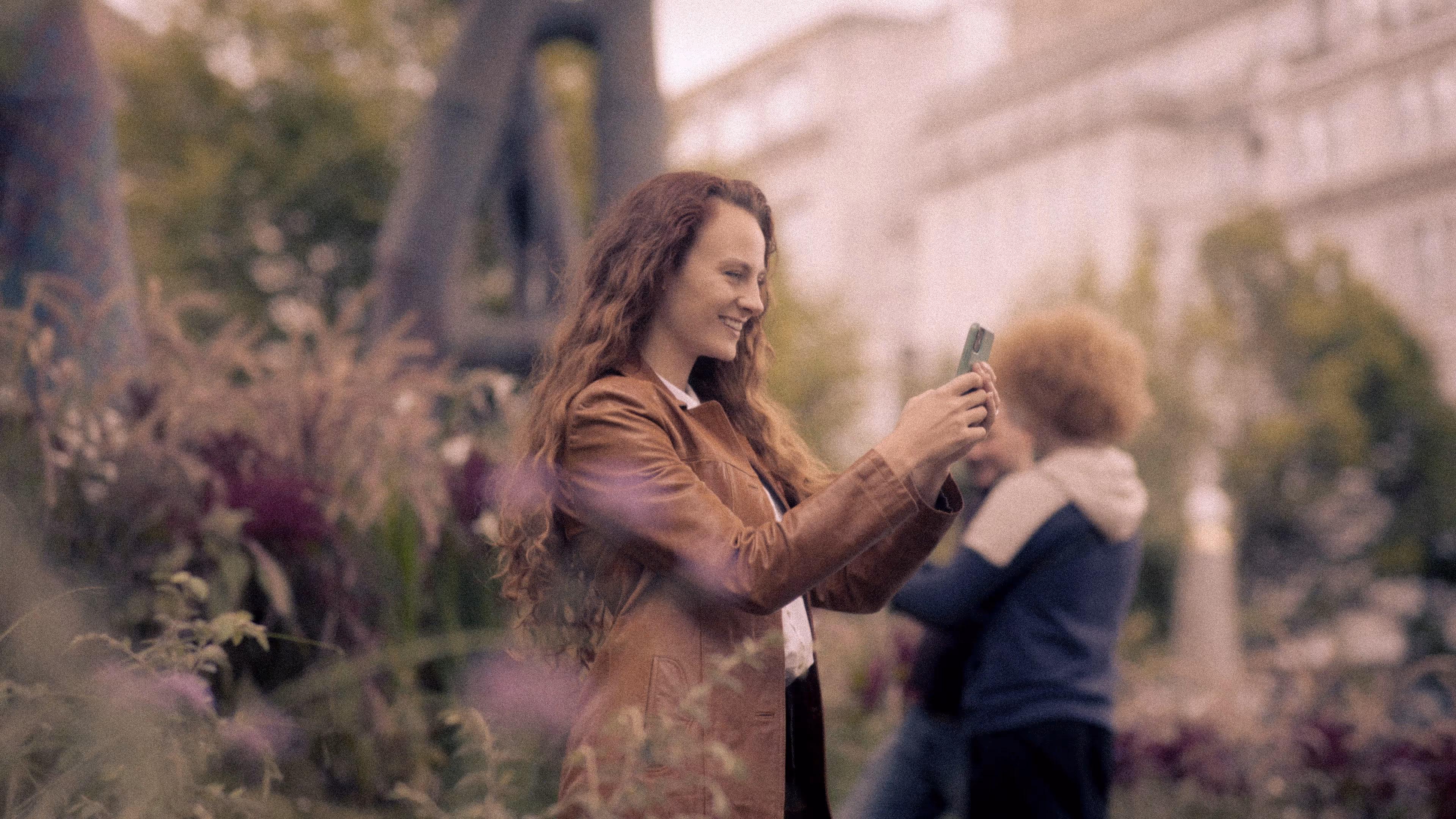Image of female with phone in hand
