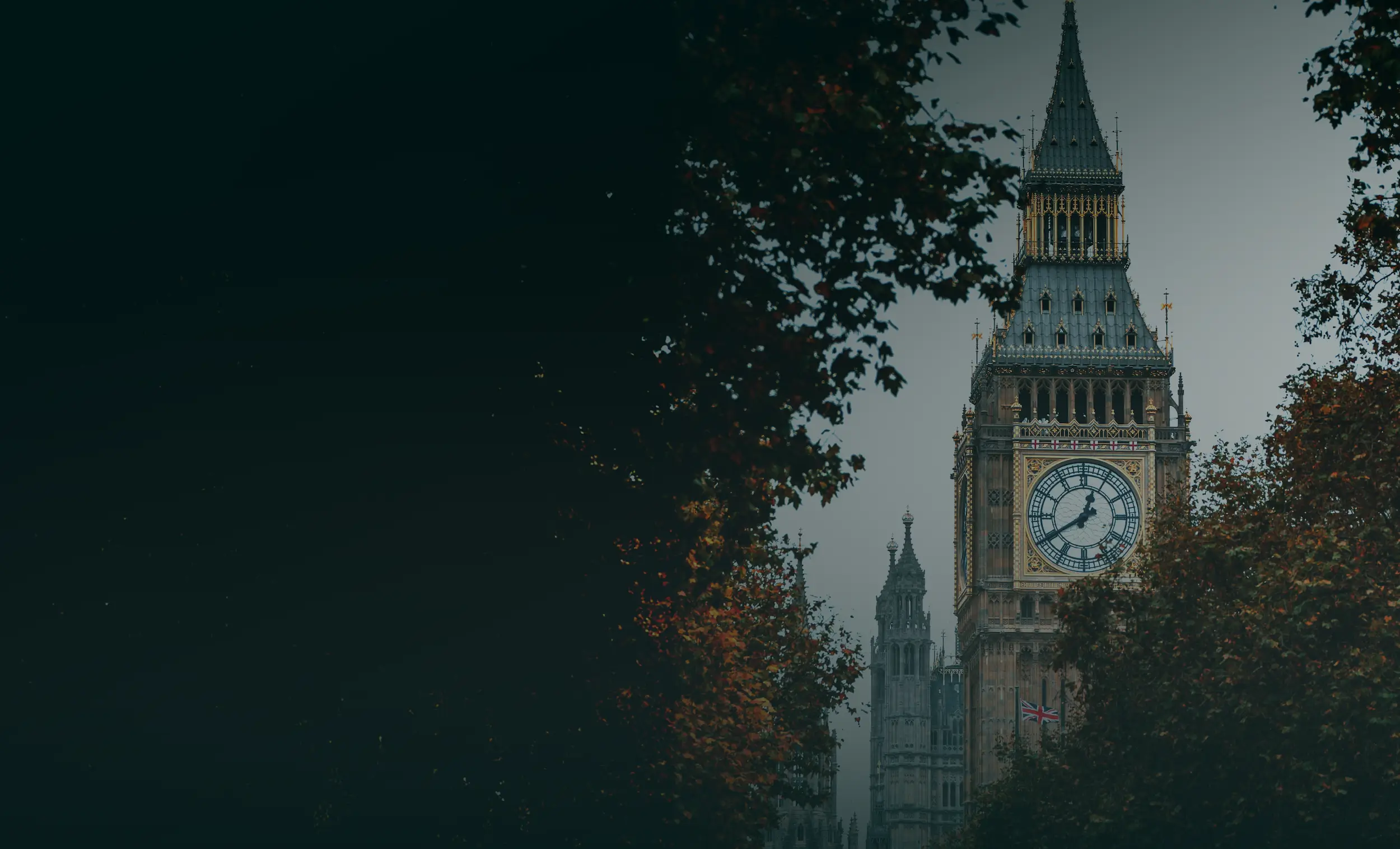a landscape picture with some leafy trees and the clock tower of a famous london building