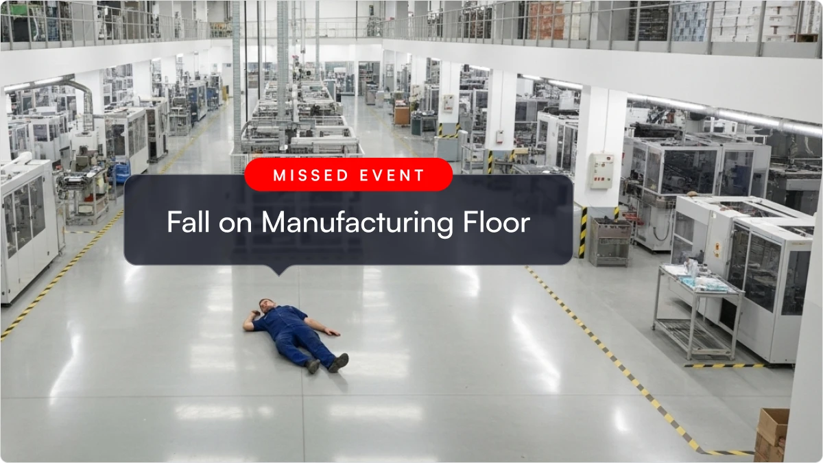 A man lying on a manufacturing floor.