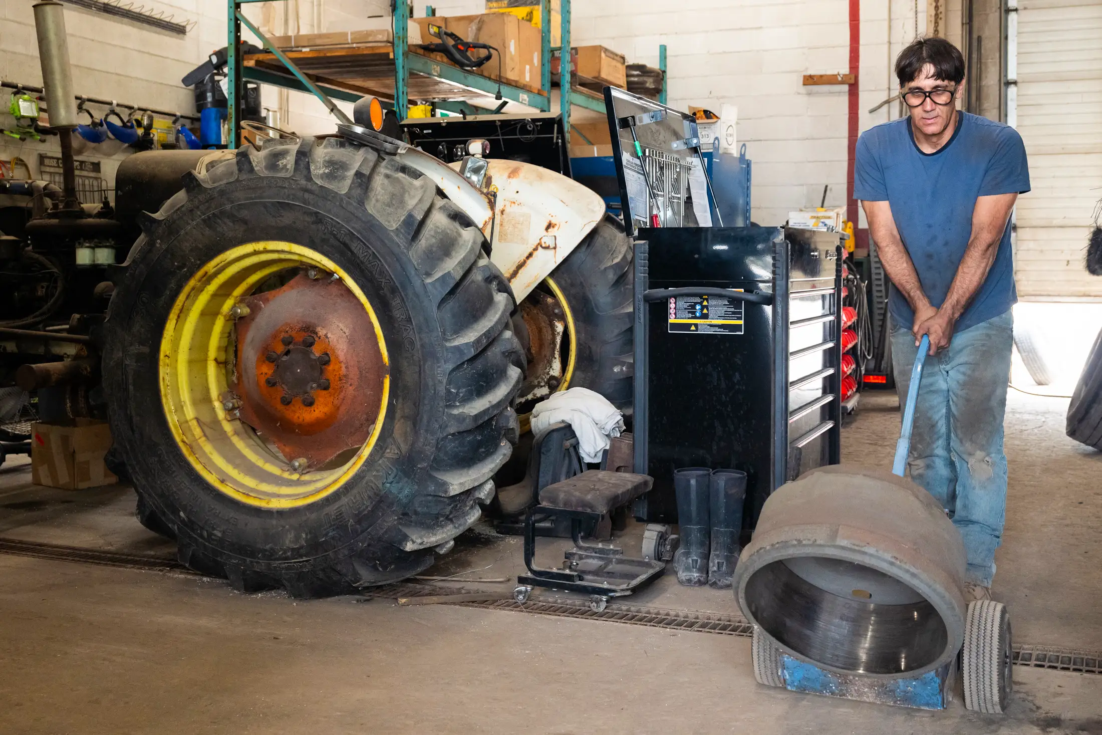 Mechanic performing repairs on tractor
