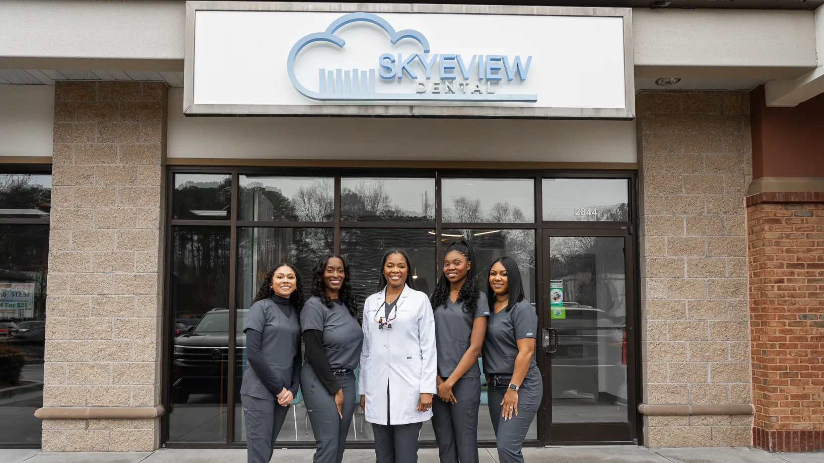 A group of women standing in front of a building.
