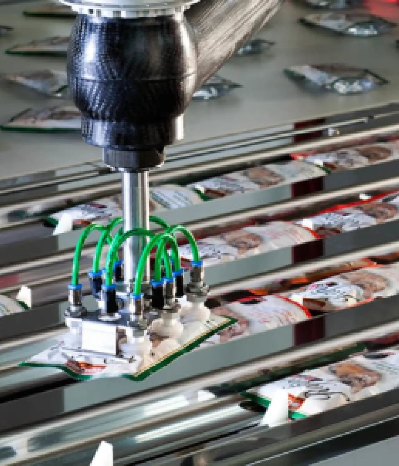 Automated robotic equipment handling packaged products on a food manufacturing production line.