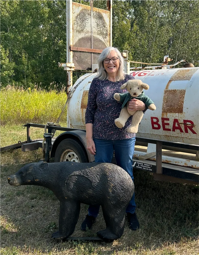 Woman standing beside a small bear next to a truck – Throwback Thursday photo