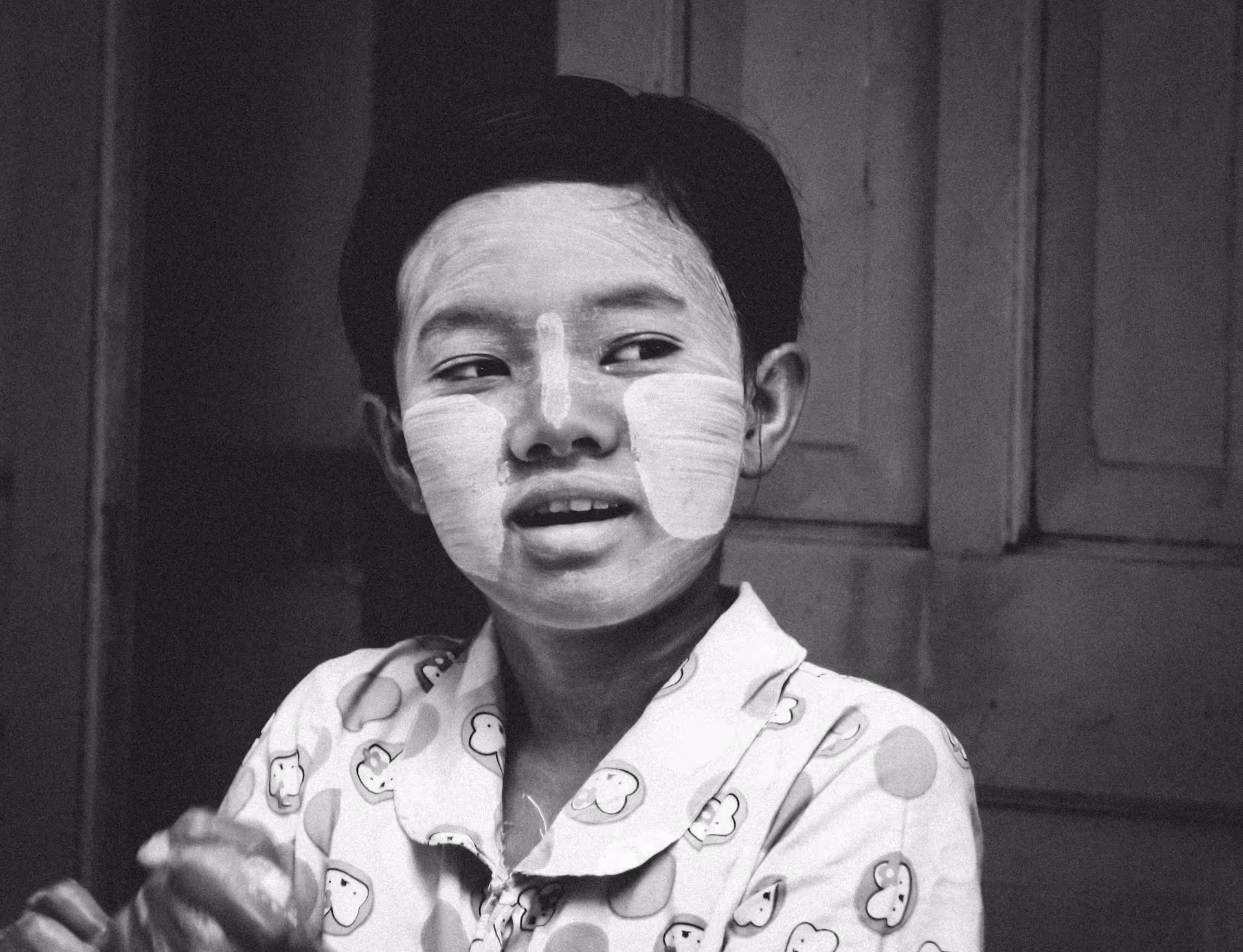 Young boy in a striped shirt looking at camera indoors – Throwback Thursday photo.