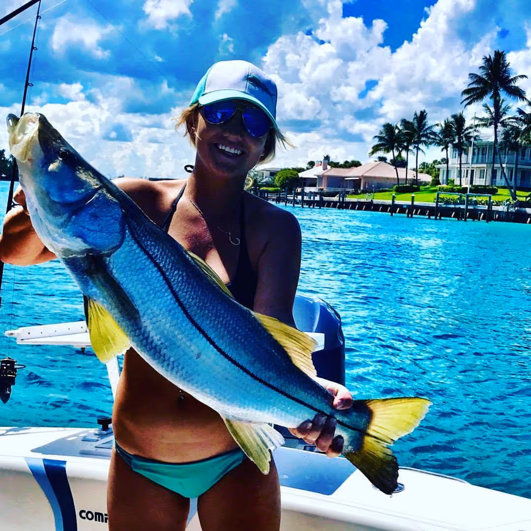 Holly Given holding up her snook catch.