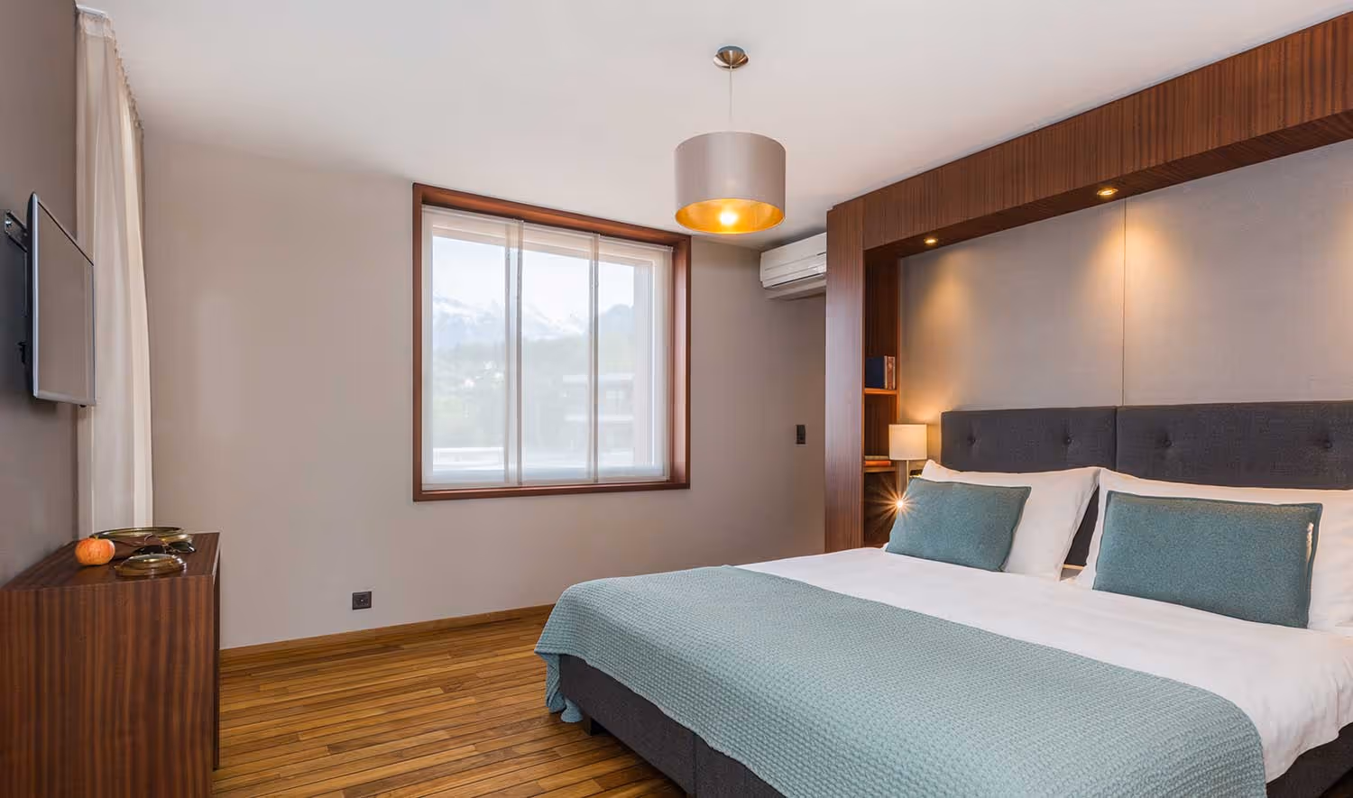 Lake villa room with double bed and window overlooking Lake Thun