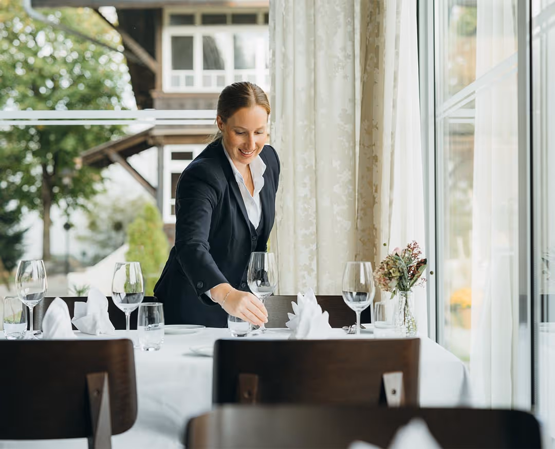 Restaurant specialist sets the table