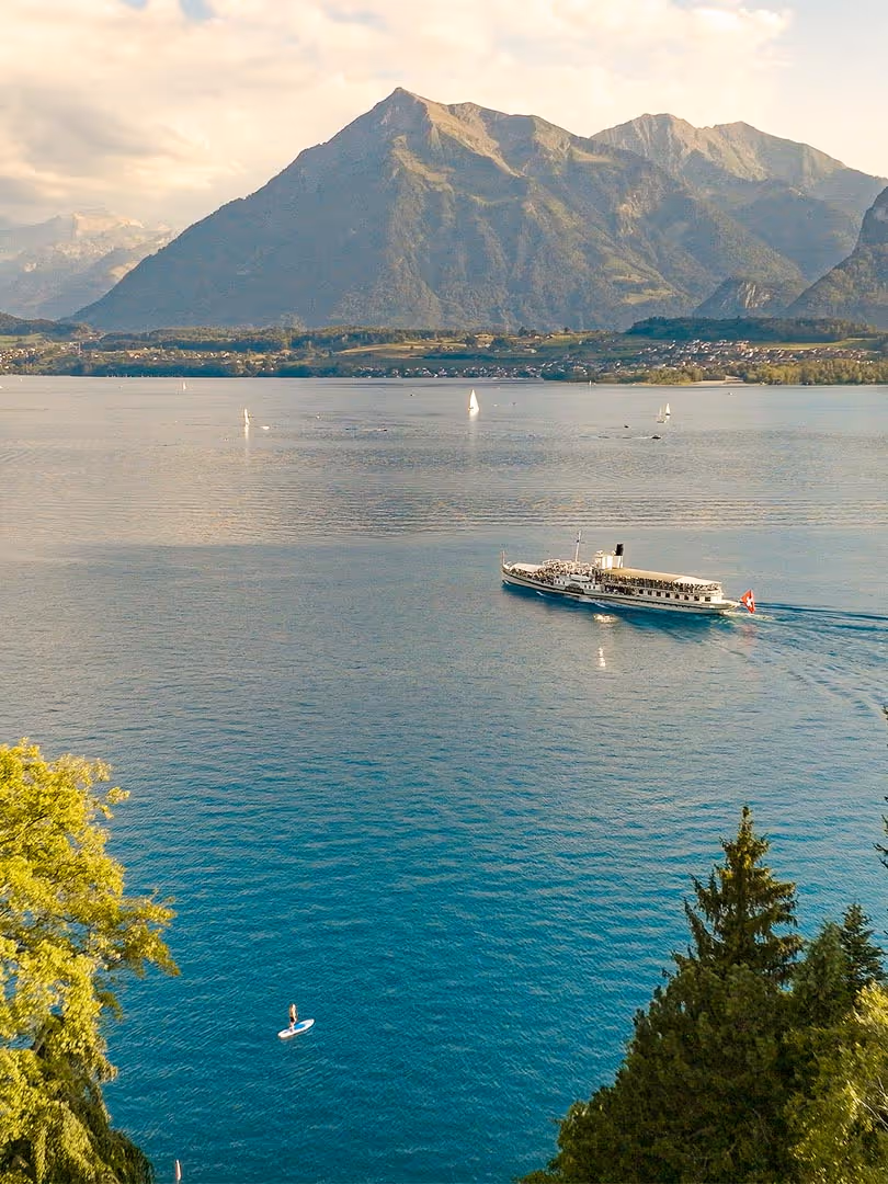 Lake Thun with a boat and the Niesen in the background