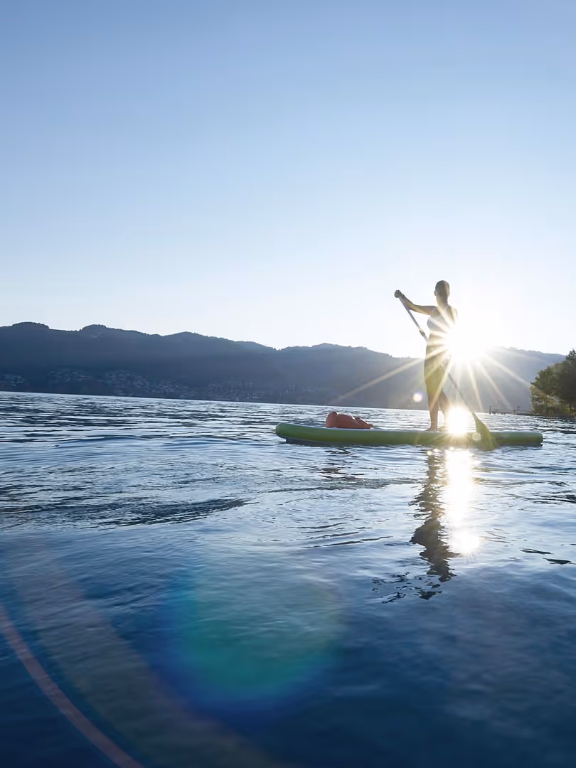 Stand-up paddling on Lake Thun at sunrise