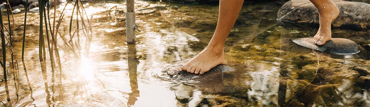 Barefoot path with stones in the water
