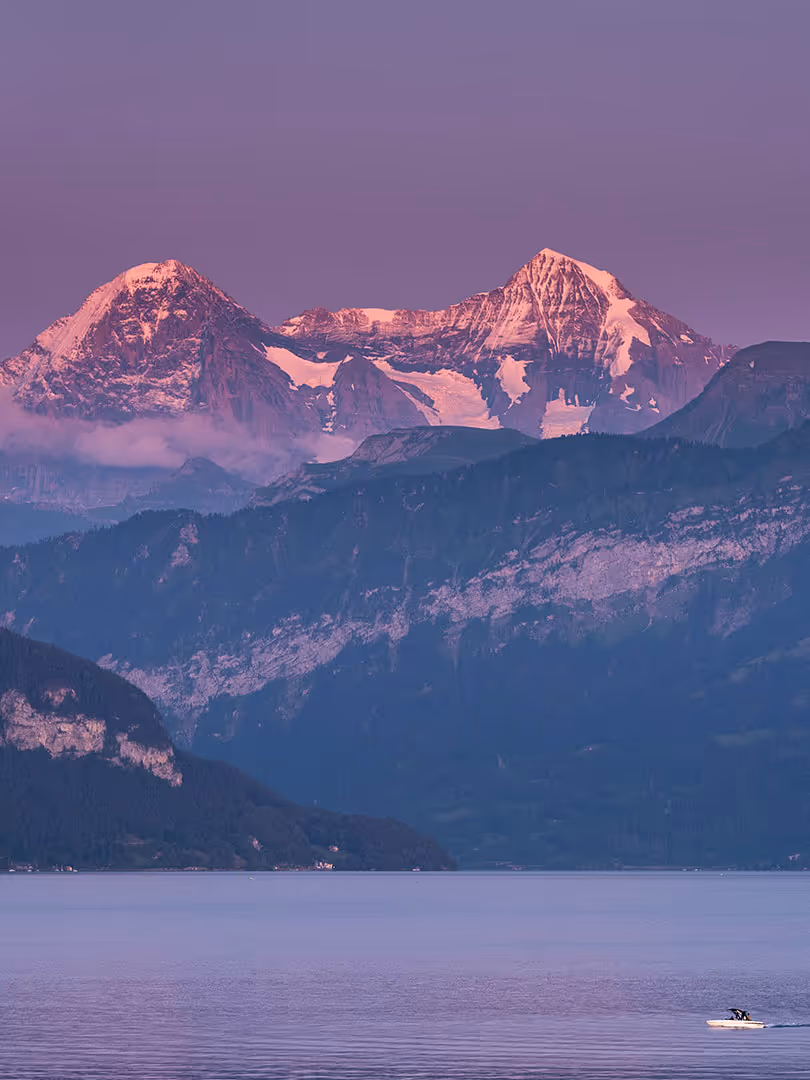 Evening atmosphere with Lake Thun in the foreground, Eiger and Mönch in the background