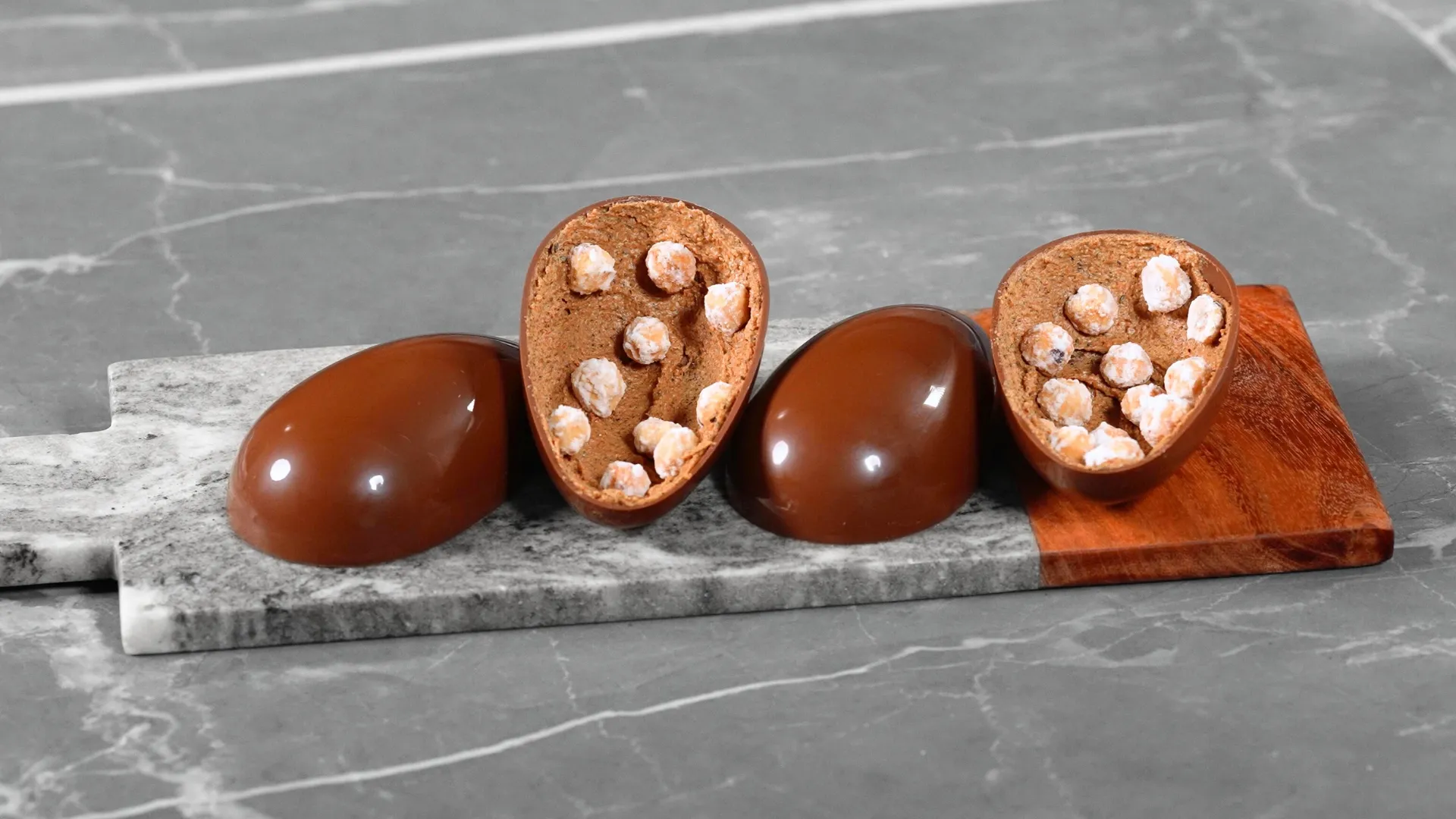 Shiny chocolate egg with hazelnuts