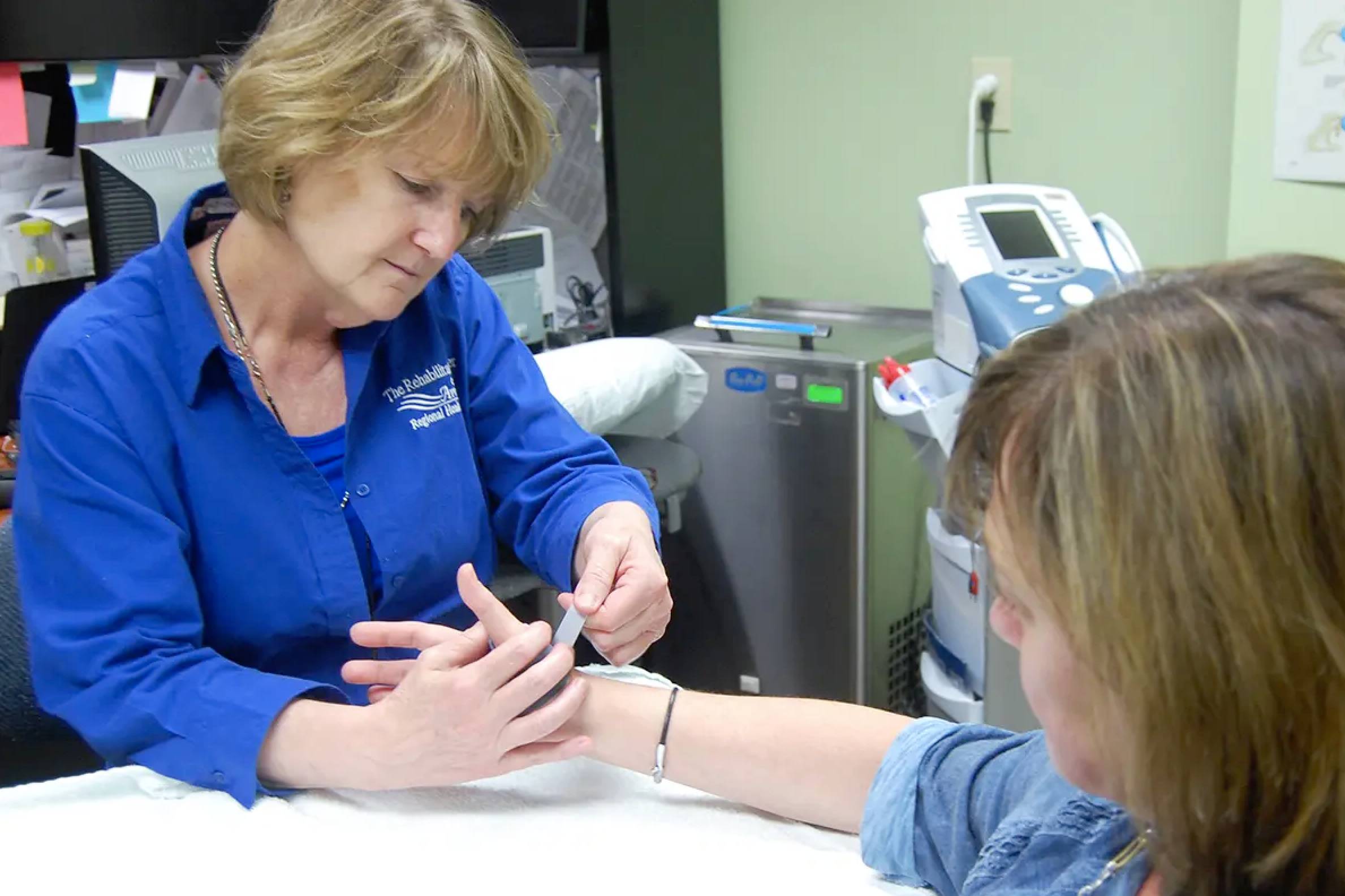 A nurse checking a woman's blood pressure