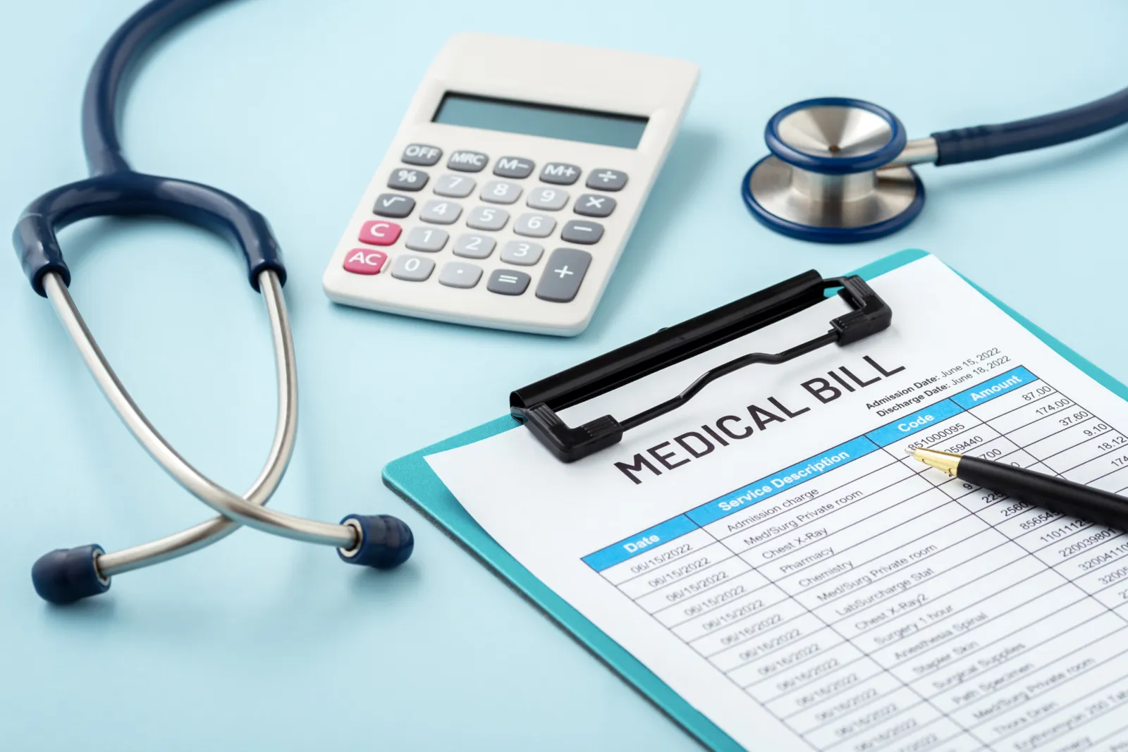 Medical bill on a clipboard with a stethoscope and calculator