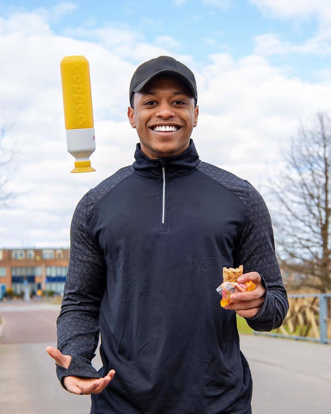 Man eating a bar and a Dopper bottle thrown in the air
