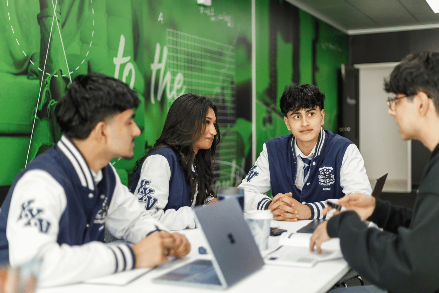 HSC maths tutor looking over the shoulder of a student to check their working out