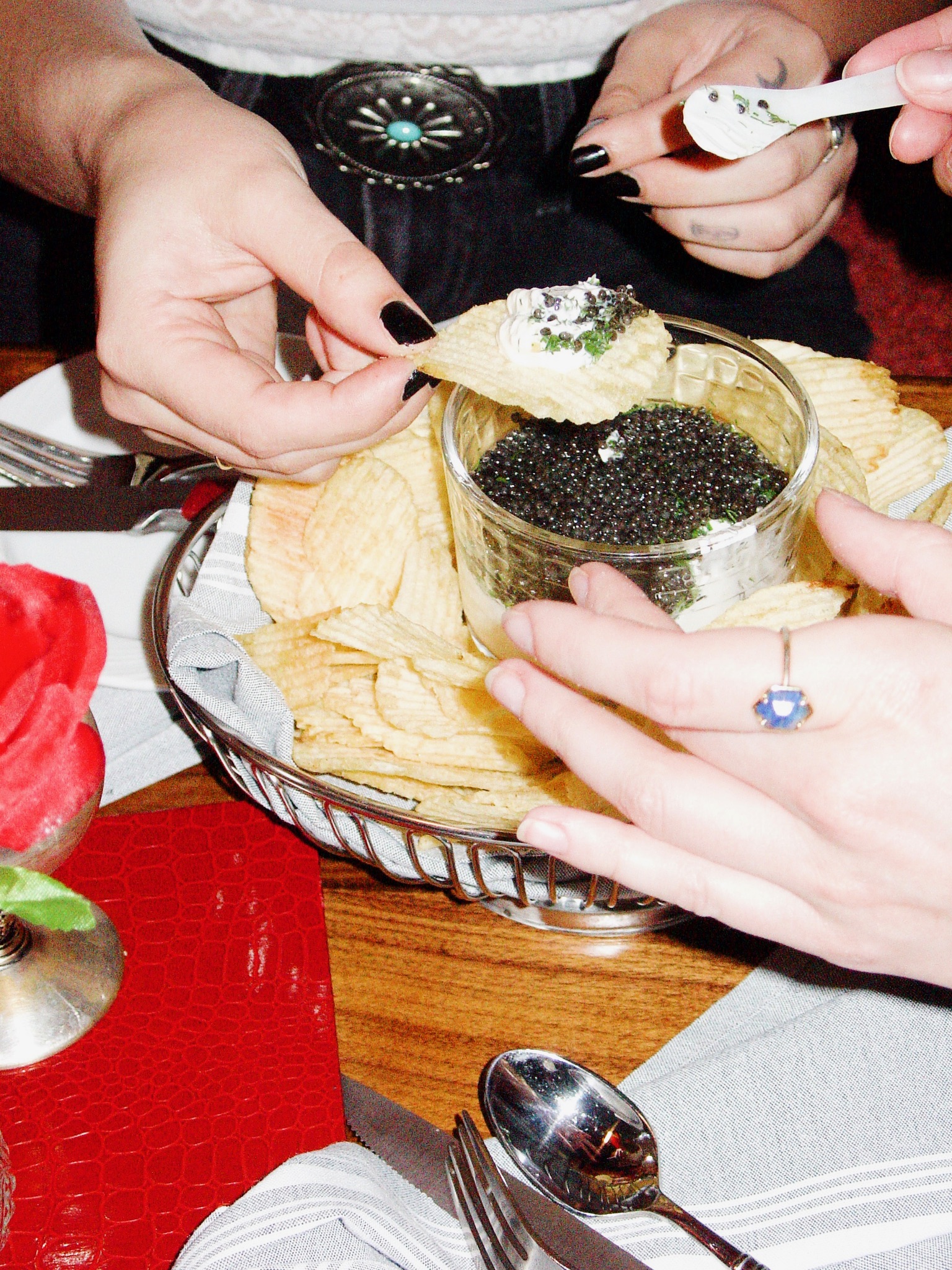 A guest eating dinner showing cheese pulling between a bite