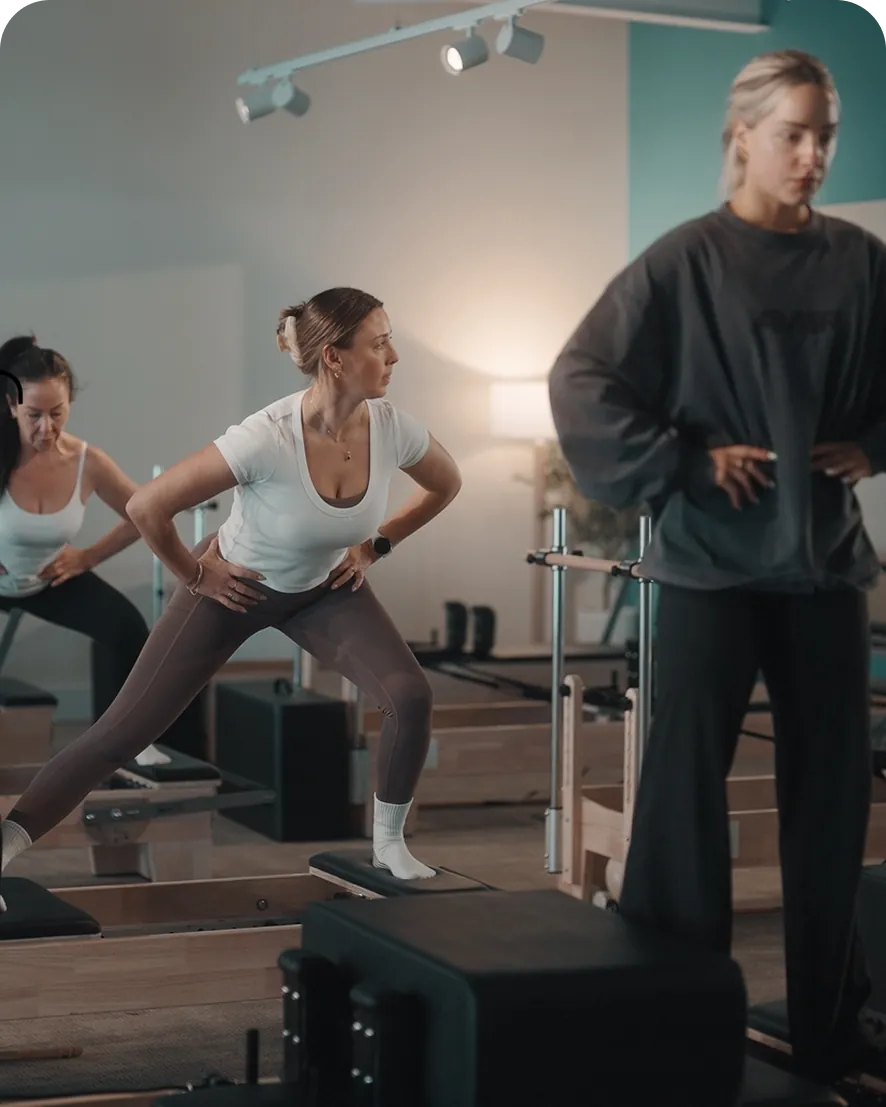 An inLIFE Wellness instructor and members during a reformer Pilates class