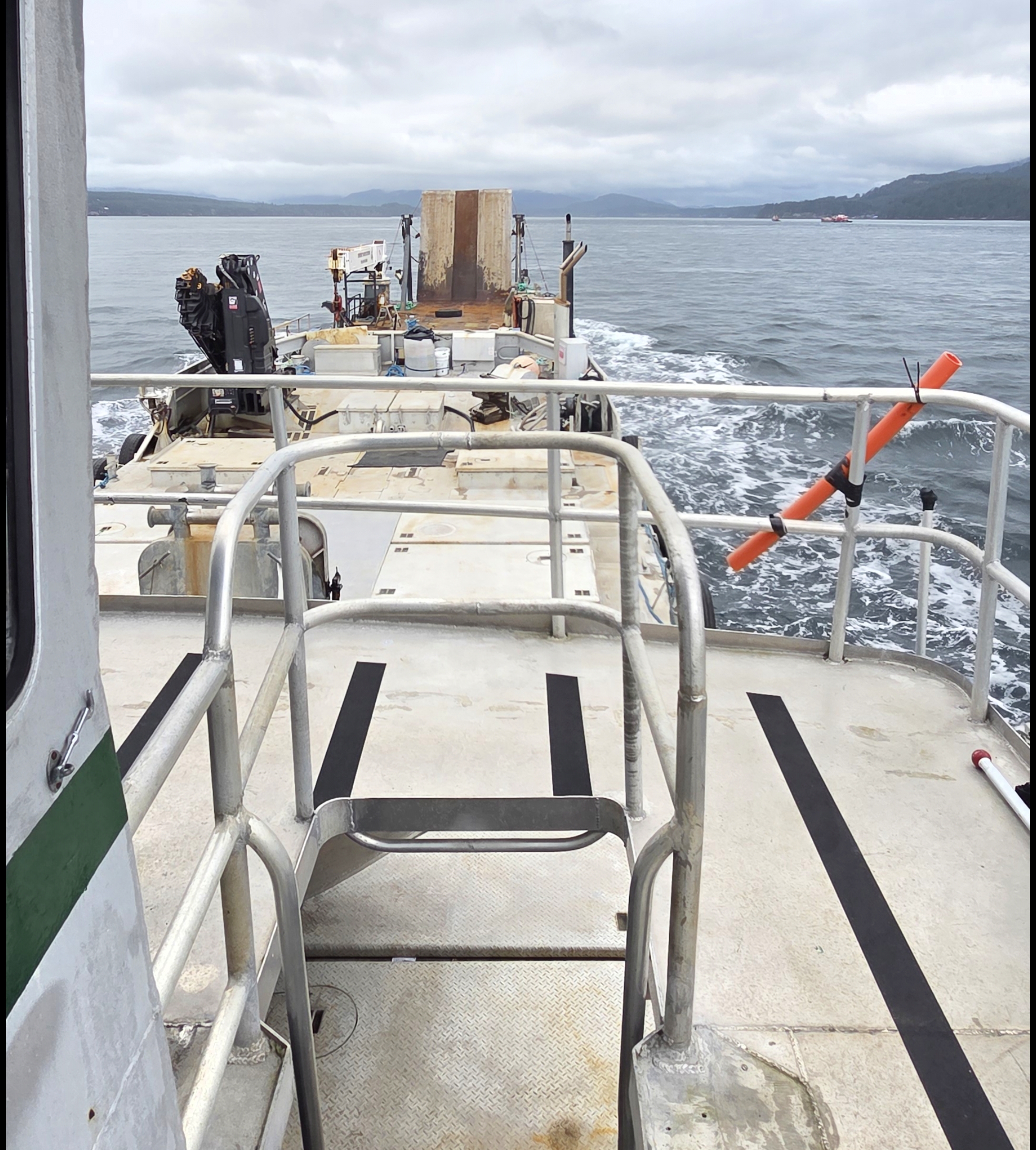 View from the tug Pacific Spray pushing the ramp barge Obelix for Western Marine Express, heading to Campbell River Marine Terminal to load 10-ton cement anchors for dock installation.