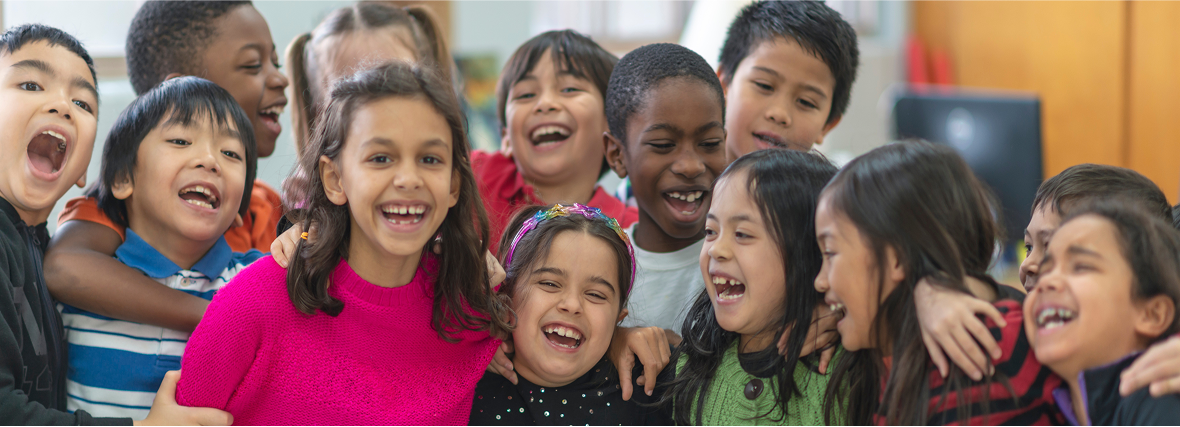 A mixed race group of elementary school kids smiling- The Fellowship Images
