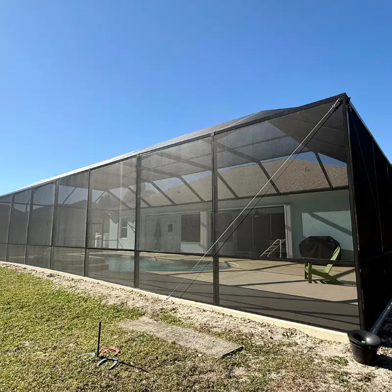 A contractor inspecting deck joists for structural integrity to ensure it can support a new enclosure - cost of screened A contractor inspecting deck joists for structural integrity to ensure it can support a new enclosure - cost of screened