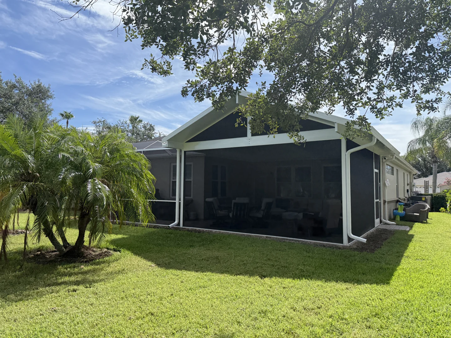 A large 200-square-foot covered porch with modern furniture - cost to build a covered porch