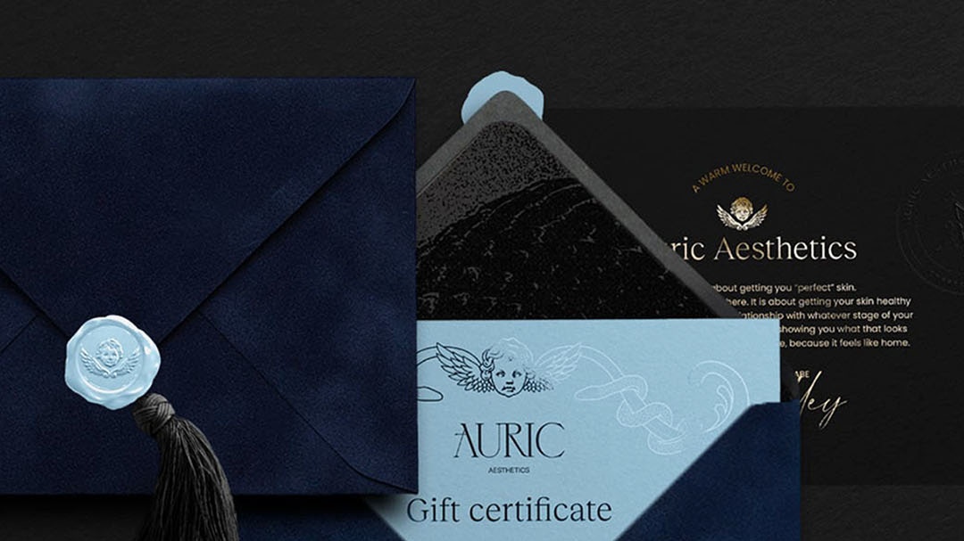 Auric Aesthetics velvet envelope gift certificate with wax seal and tassel