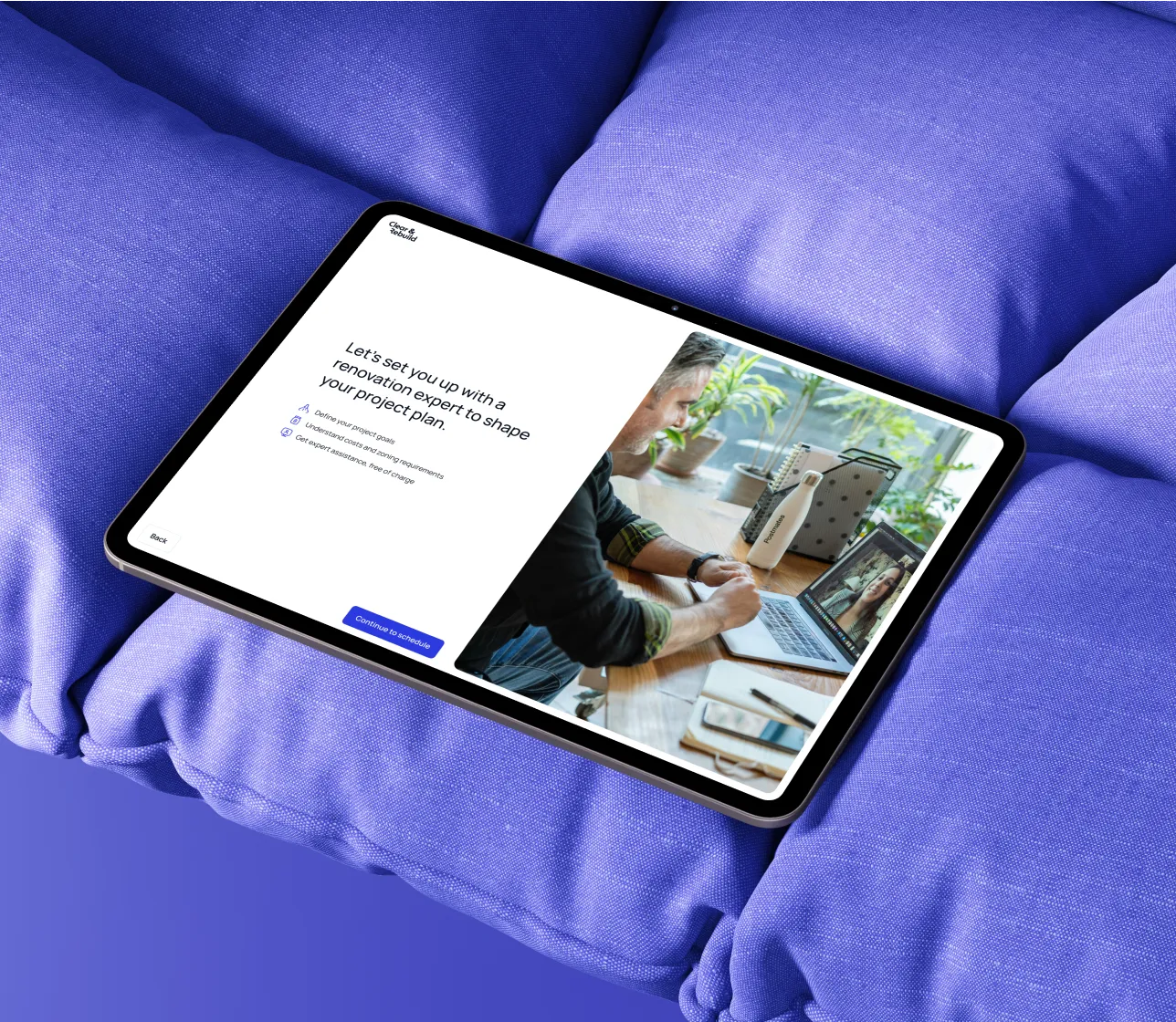 Tablet on purple cushion displaying a renovation expert scheduling page and a video call with a woman.