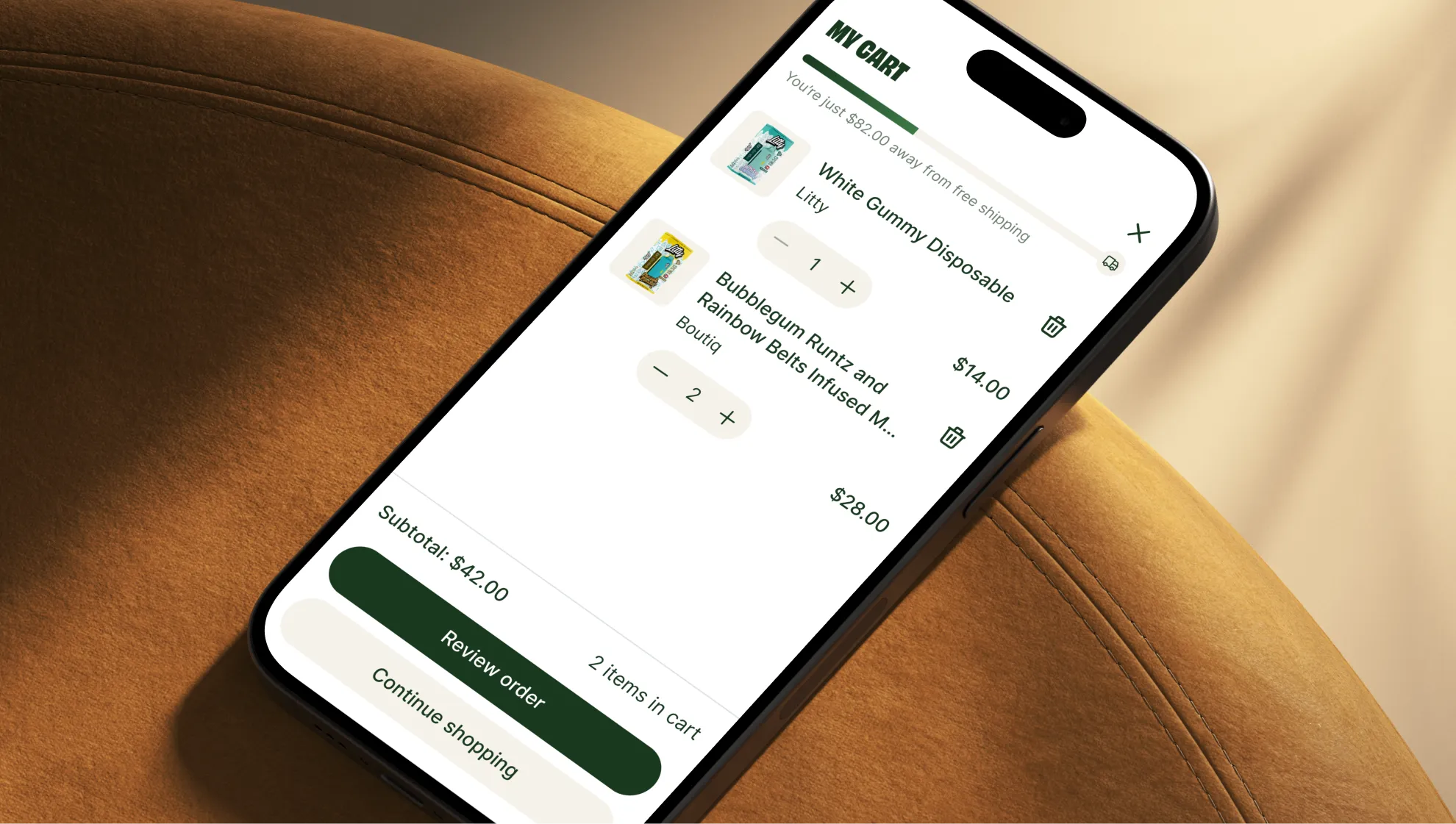 Smartphone displaying a shopping cart with two items: White Gummy Disposable and Bubblegum Runtz and Rainbow Belts Infused, showing item quantities and subtotal of $42.00.