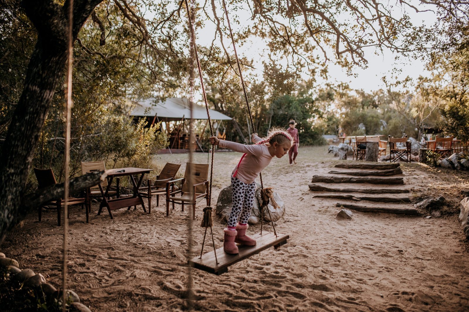 A child on the tree swing in camp