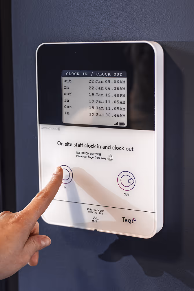 A photo of a person using a TaqtOne, a wireless digital timeclock