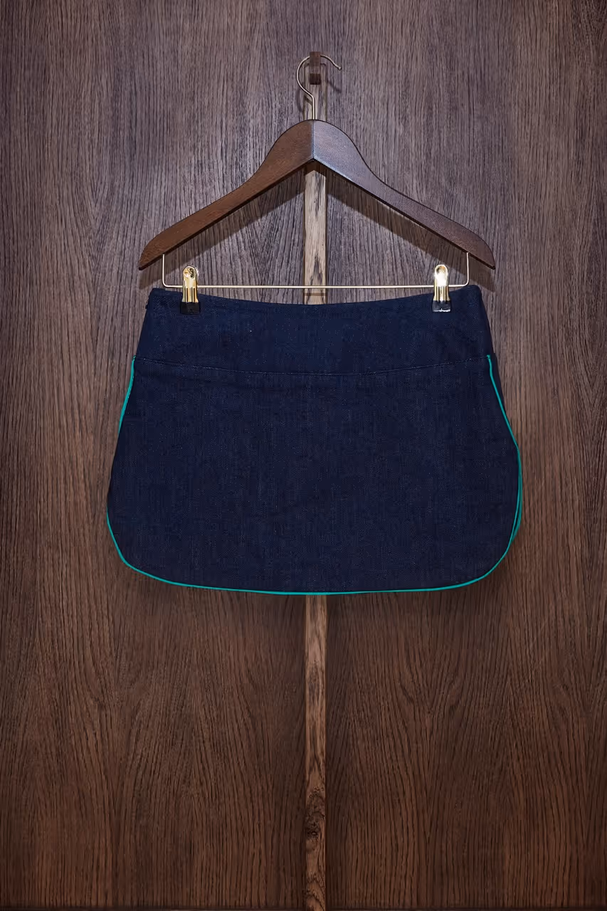 Mini skirt in lined denim, low waist marked by a denim panel, rounded side slits with piping finishes, invisible side zipper, pockets made out of lined vintage embroidered napkin. Denim : 98% cotton - 2% lycra Napkin : 100% cottonLining : 100% cottonDry Cleaning Only.Made in South of France.The embroidered napkin is a unique piece.