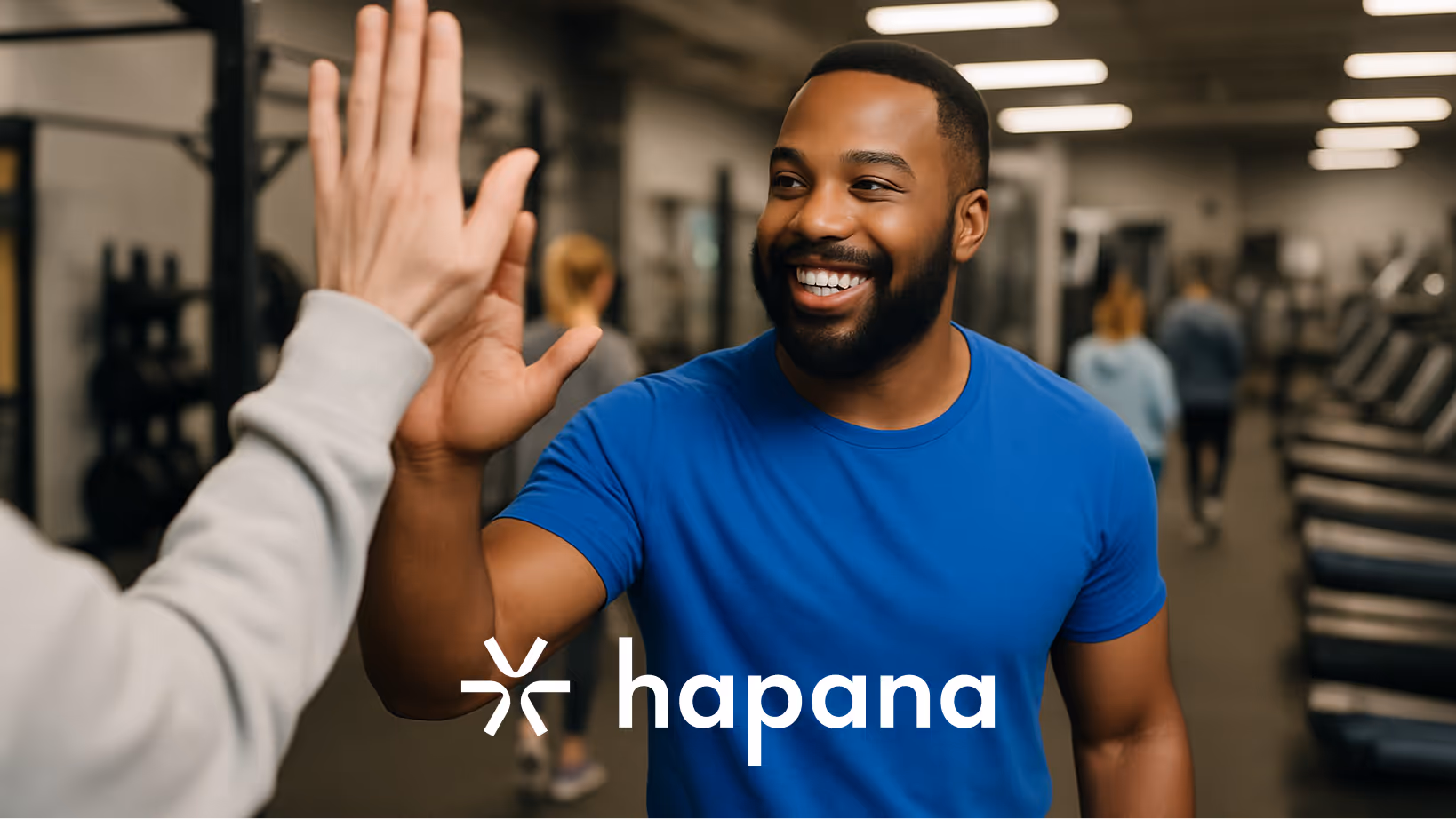Smiling gym member getting a high five and feeling appreciated