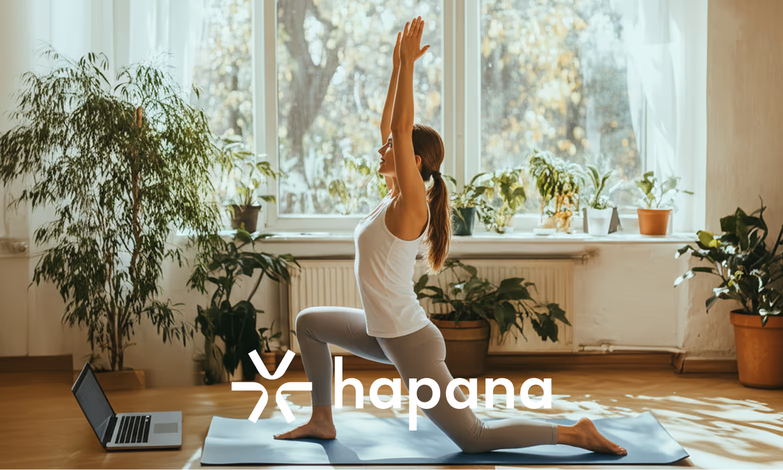 Woman going virtual yoga class on her laptop