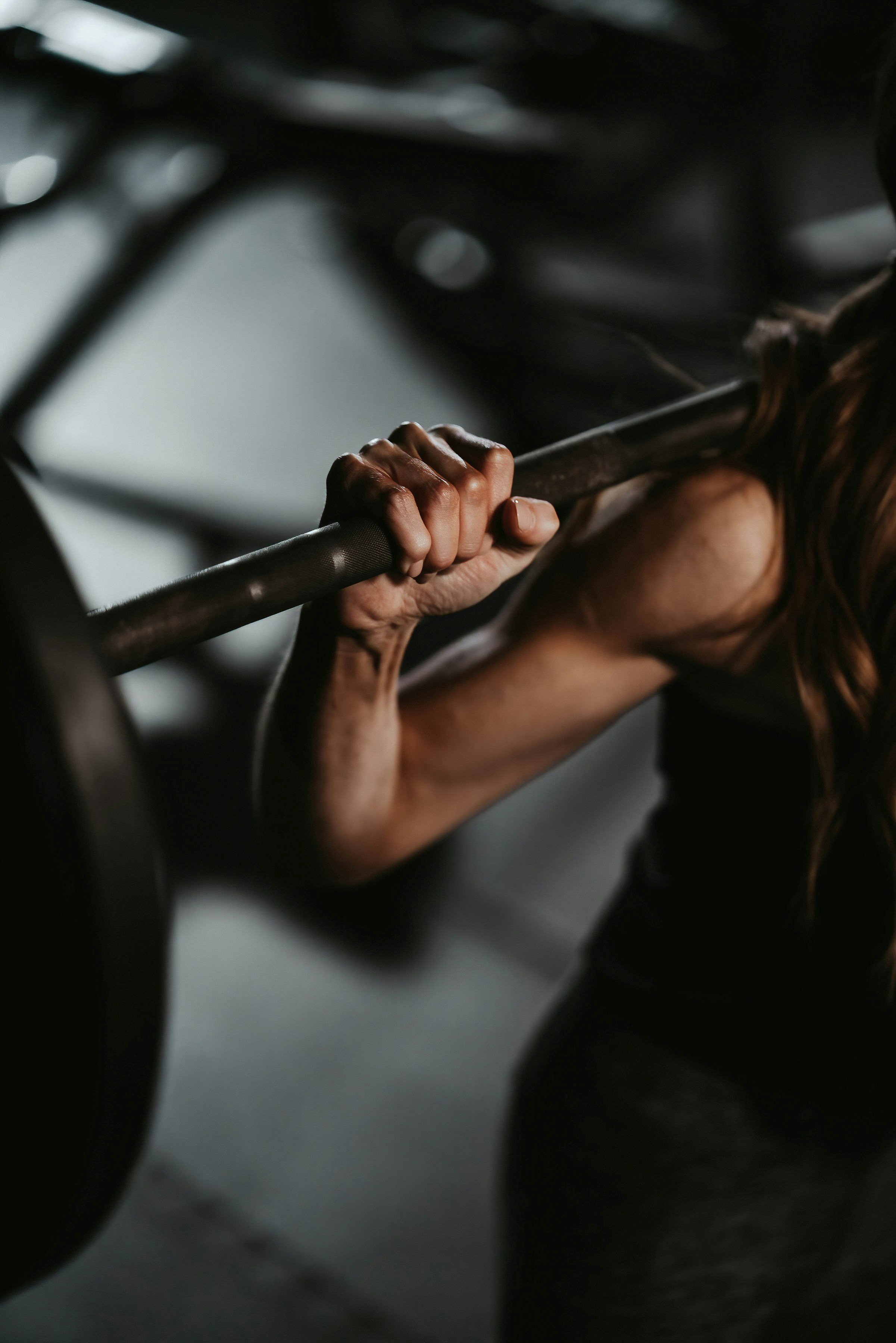 woman with barbell getting ready to squat