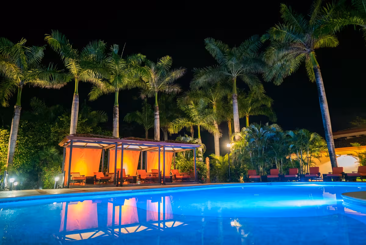 Rythmia's saltwater pool and gazebos at night.