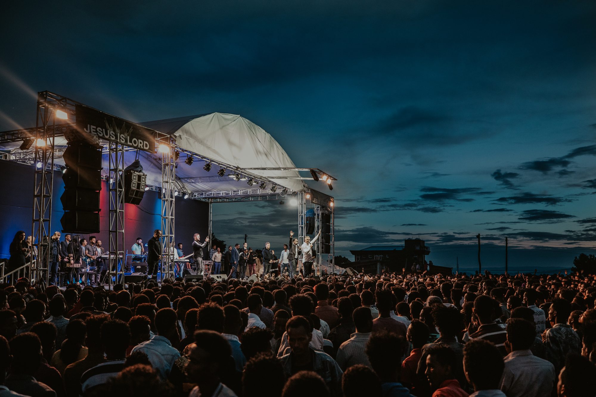 Night crusade with a large crowd gathered at the stage