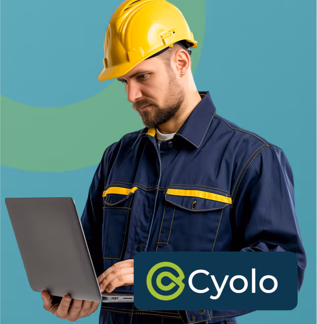 Man wearing a yellow construction helmet and navy work jacket using a laptop, with the Cyolo logo in the foreground.
