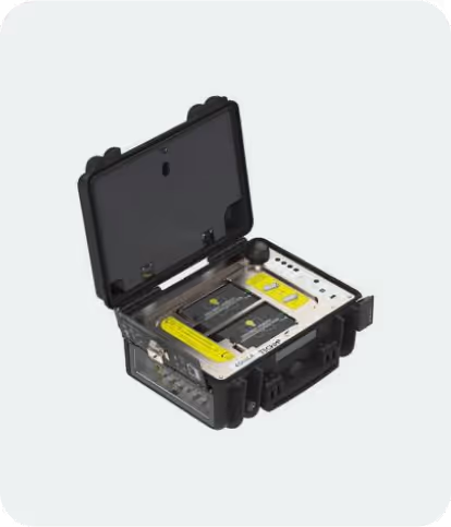 Black rugged case open showing organized electronic equipment with buttons, labels, and several connectors inside.