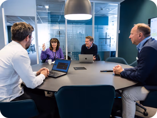 A team in the office discussing work processes