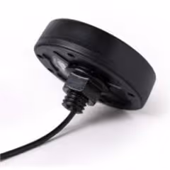Black circular LTE omnidirectional antenna with cable attached.